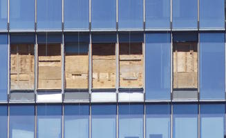 Boarded-up windows in modern building