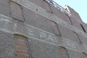 Faded paint, possibly reading “The Bakery”