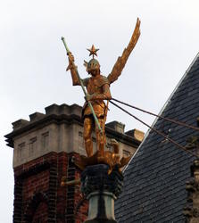 golden knight with wings slaying dragon