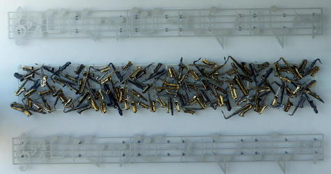 Musical notes above and below an array of saxophones