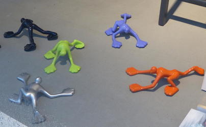 Multicolored plastic men on all fours