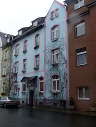 Light blue house with light purple borders around windows