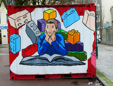 boy reading book thinking of legos
