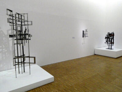 Three metal sculptures comoposed of multiple rectangular shapes