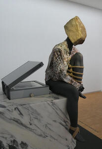 seated women with stone for head