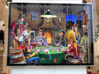 Painting of John Wayne, Clint Eastwood, Yul Brynner, Yosemite Sam, Lucky Luke, and Woody from Toy Story playing cards