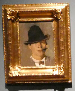 man in hat smoking small cigar