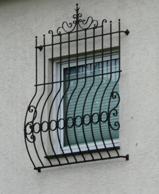 curved iron bars in front of window