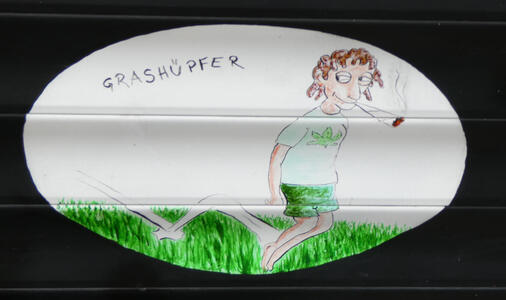 Man hopping through grass and smoking large marijuana cigarette