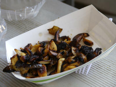 Paper bowl filled with roasted garlic