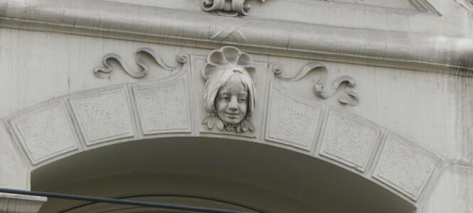Relief sculpture of woman with pigtails.