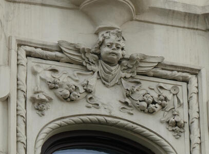 Reliefwork of cherub. Beneath it, flowers