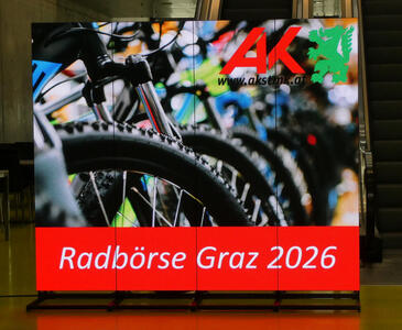 LED display with picture of bicycle tires. Text: Radbörse Graz 2026