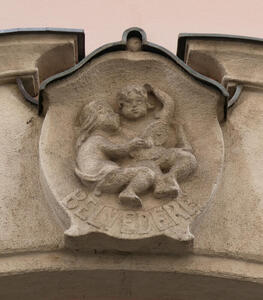 Old circular shield with carved cherubs; beneath it, the word BELVEDERE
