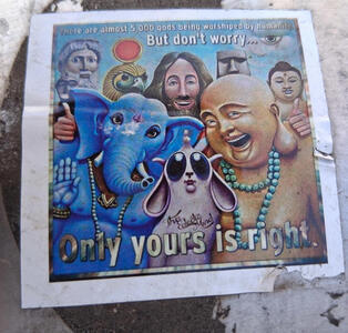 Smiling Jesus giving “thumbs up”. He is surrounded by Ganesh, Horus, Buddha, and other religious figures. Text: There are almost 5,000 gods being worshiped by humanity. But don’t worry...Only yours is right.