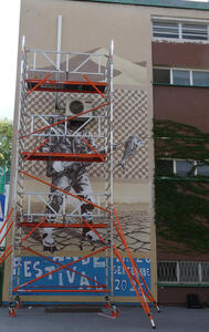 Scaffolding in front of an artwork in progress.