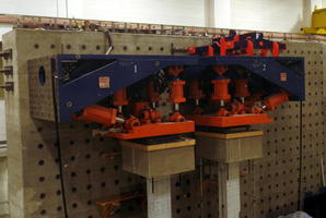 Large orange pistons above concrete columns