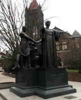 Statue of woman holding arms in welcoming gesture