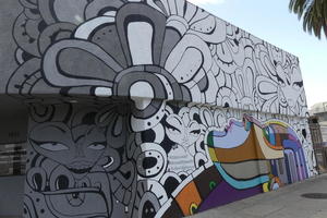 painted faces on side of building