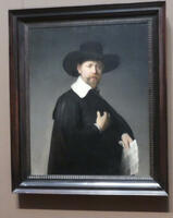Portrait by Rembrandt of man with beard and black hat and robe