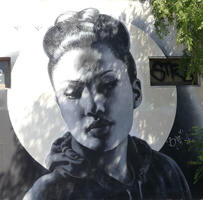 Spray painted picture of woman wearing hoodie.