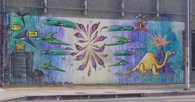 Dinosaur and shark/ameoba-like creatures on parking structure wall