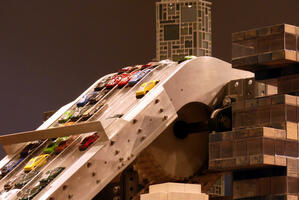 Cars being carried to top of installlation by conveyor belt