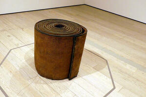Rolled rubber mat with 300,000 nails driven into it.