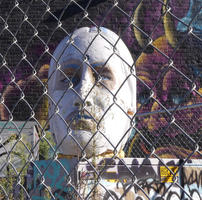 Large sculpture of human head in egg-white except for caucasian flesh color around eyes and mouth