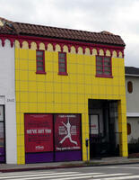 Building with square yellow tiles on front