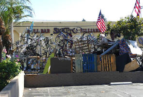 Homeless encampment with bicycles piled up to height of 2.5 meters