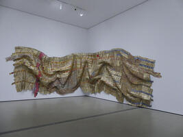 Gold, red, and silver metallic squares in a hanging sculpture