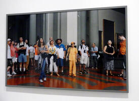 Photo of people in an art gallery in italy looking upwards at an (unseen) art piece