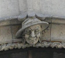 Woman with broad-brimmed hat and earrings