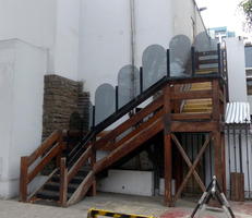 Wooden stairway with arched glass panels along side