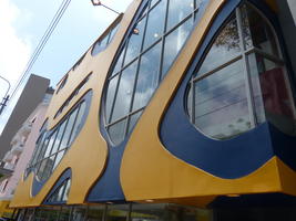 Abstract blue and yellow design on 2nd floor of building.