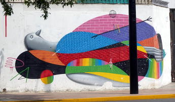 Large wall painting of a bird on its back; multi-colored.