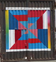 Metal gate painted in multi-colored geometric design