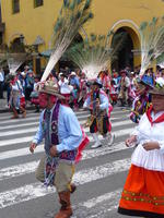Man in mask; hat has peacock feathers in it.