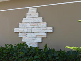 white stones forming shape of diamond on a wall