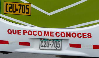 Sign on rear bumper of bus