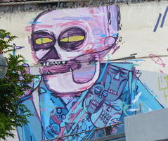 Wall art of face like a skull with yellow eyes