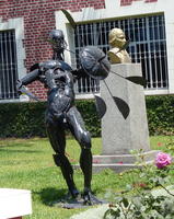 Metal sculpture of man with shield that rotates