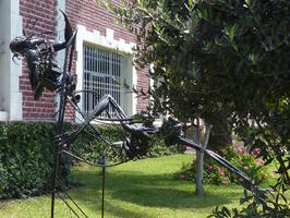Metal sculpture of reclining person