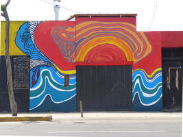 Building with bird beak painted across top of door and side walls