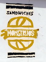 Sign for “Monstrous Sandwiches” shop; word “Monstrous” inside a sandwich
