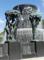 People in tree branches (around perimeter of fountain)