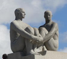 Two seated men in 3/4 profile towards each other