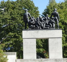 Bronze figures atop concrete rectangular arch