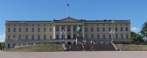 Large yellow building with greek columns in center